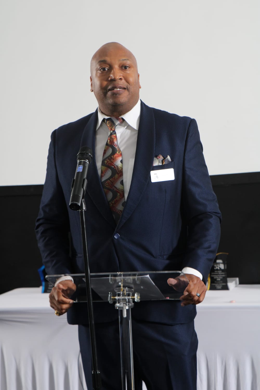 Percy Scott speaking at a lectern